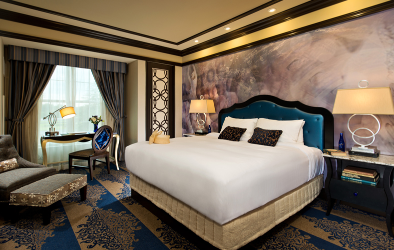 Hotel room featuring king bed and Victorian writing table
