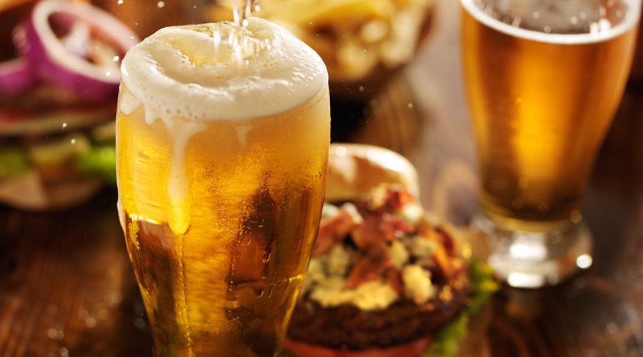 Glass of draft beer and a burger from Mane Bar